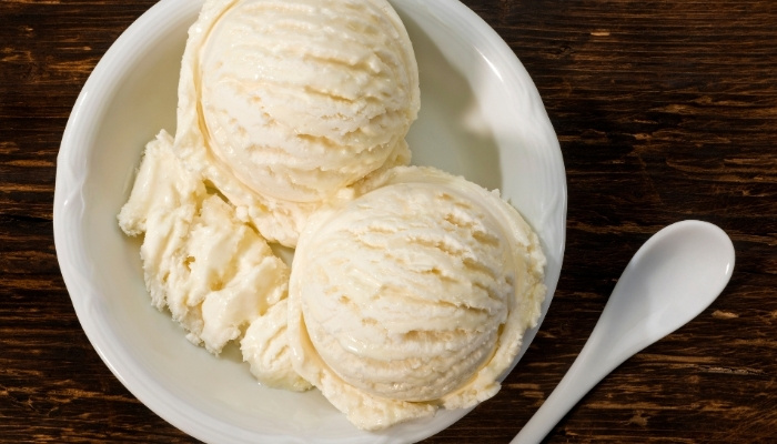 Two scoops of vanilla ice cream at The Hill Bar & Grill in Glyndon MN, served in a white bowl.