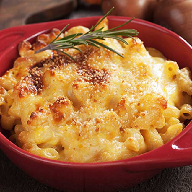 Baked macaroni and cheese at our restaurant in Glyndon MN, topped with golden melted cheese.