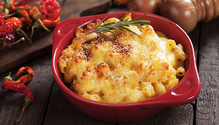Baked macaroni and cheese at a restaurant in Glyndon MN, topped with herbs and golden cheese.