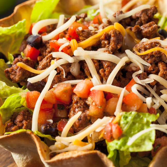 Taco salad in a tortilla bowl at our restaurant in Glyndon MN, loaded with fresh toppings.